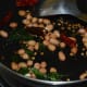 Add peanuts. Saute until they roast.