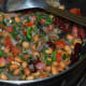 Saute the mixture until the leafy greens wilt.