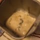 Softened yeast and warm water in the bread maker mold. Ready for the rest of the ingredients.