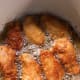 Continue frying the chicken, turning each piece every 2 minutes. Cook until the pieces turn golden brown.