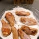 Dredge the chicken pieces through the dry mixture.