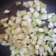 Add the ridge gourd chunks to the pan.