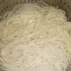 Drain cooked noodles in a colander and wash under cold water. Reserve some cooking water for later use.