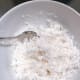 In a small bowl, combine the grated coconut and salt. Mix thoroughly. Set aside.