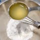 Combine the icing sugar and the freshly squeezed lemon juice.