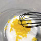 Add the freshly grated lemon zest into the sugar. Use a whisk to combine.