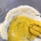 Add two large eggs into the mixture and mix to combine.