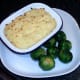 Mashed potato and cocktail sausage pie with Brussels sprouts