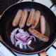 Onion is briefly fried with sausages