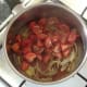 Chopped tomatoes and seasonings are added to sauteed onion