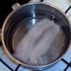 Gently poaching pollack fillet in water