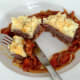 Enjoying buffalo, tomato and basil burger with crispy cheese mash and tomato sauce