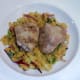Chicken thighs are laid on curried mash bed