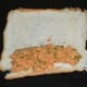 Step three: Place 1 teaspoon of the stuffing on the one edge of the bread. Roll it along with the stuffing to make a roll.