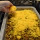 Evenly spread the grated cheese atop the meat layer.