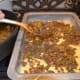 Spread about 1/3 to 1/2 of the corn bread batter into a greased (sprayed) baking pan, then layer on the seasoned, browned meat.