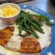 Blackened tilapia on the plate with two of three sides