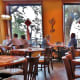 Bright lit dining room with windows overlooking patio area