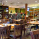 The other side of the main dining area divided by a bookcase and wine storage
