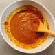 Curry powder paste. Mix water into the curry powder and stir until it becomes a smooth and thick paste.