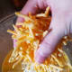 Add a handful of cheddar cheese. Stir.