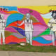 The "New Art Era" mural on Polk Street near the "We Love Houston" sculpture by David Adickes