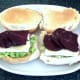 Beetroot slices are laid on corned beef and cheese and seasoned with black pepper