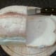 Slices are cut from a farmhouse loaf
