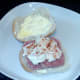 Coleslaw is spooned on to corned beef and dusted with chilli powder