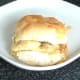 Top is placed on corned beef, tomato and onion with melted cheese roll