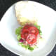 Sliced tomato is arranged on top of corned beef