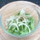Sliced lettuce and onion are seasoned and combined