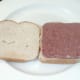 Corned beef arranged on one slice of bread