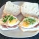 Chopped coriander/cilantro garnishes eggs before rolls are closed over