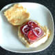 Sliced corned beef, tomato and onion on toasted bread roll