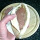 Corned beef slices are laid in pitta pocket