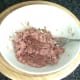 Corned beef is mashed with the back of a fork