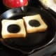 Add toast un-buttered side down in a skillet.
