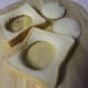 Cut holes in bread slices with a biscuit cutter.