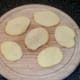 Potato slices are seasoned