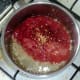 Tomatoes and chillies are added to sauteed garlic
