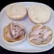 Chicken thigh meat is arranged on top of potato slices