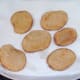Fried potatoes are drained on kitchen paper