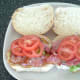Tomato slices are laid on top of bacon
