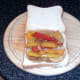Peppers and onion are arranged on top of potato slices