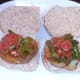 Broccoli in spicy tomato sauce is spooned on to fried potatoes in bread rolls