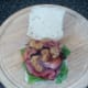 Fried prawns are arranged on bacon rashers