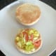 Combined tomato and lettuce on toasted roll