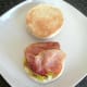 Bacon slices are laid on top of pork and apple sauce
