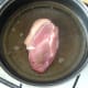 Seasoned pork fillet is put on to fry